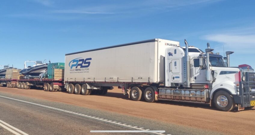 Semi-trailer truck towing boats to show how to transport a boat