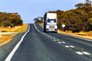 Remote road with heavy haulage truck conducting what is remote delivery